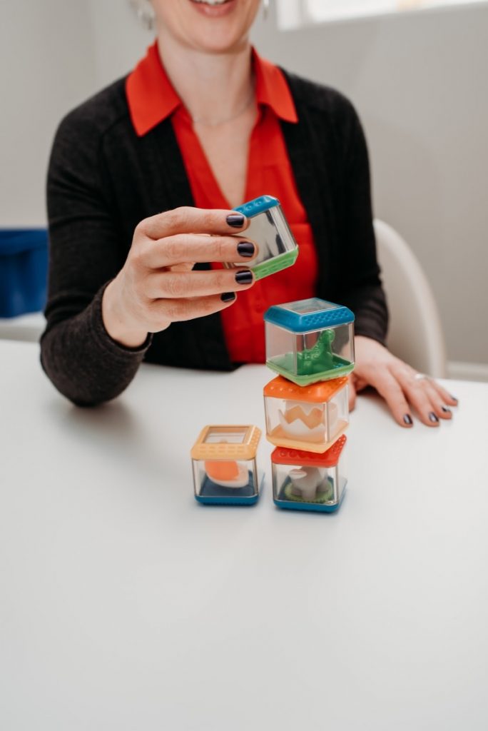 Therapist Suzanne, stacking up some of our toys.